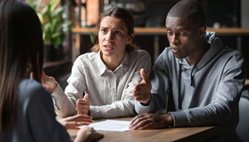 three people having arguing about insurance claim disputes