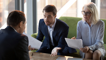three people having a conversation regarding property claim disputes